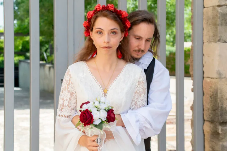 Los novios con el ramo de rosas rojas y blancas en Poblet